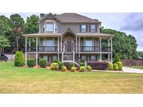 Two-story house with large deck, stone accents, and landscaped yard at 33 Riverview Trl, Euharlee, GA 30145