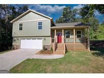 Newly constructed home with a two-car garage and inviting front porch at 520 Mountainview Dr, Covington, GA 30016