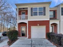 Brick front exterior of charming townhome with attached garage at 2491 Emma Way, Lawrenceville, GA 30044