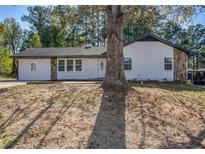 Newly renovated ranch home with a large front yard and mature tree at 2989 Menlo Park Dr, Rex, GA 30273