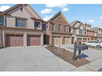 Townhomes with attached garages and neatly landscaped yards at 1762 Caswell Pkwy # 33, Marietta, GA 30060