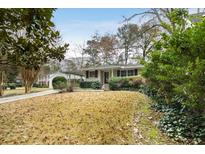 Ranch style home with mature landscaping and a spacious yard at 3027 Saint Annes Nw Ln, Atlanta, GA 30327