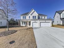 Two story white brick home with three car garage, and landscaping at 2144 Suncrest Pt, Marietta, GA 30064