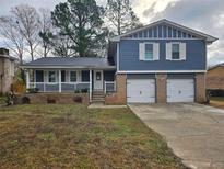 Updated two-story home with a new paint job, two-car garage and a modern front porch at 2314 Emerald Springs Dr, Decatur, GA 30035