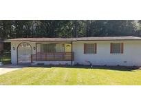 Charming ranch home with white brick exterior, wood accents, and a well-manicured lawn at 987 Forrest Se Cir, Atlanta, GA 30354