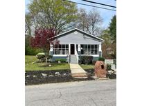Charming gray house with a screened porch and well-maintained landscaping at 25 Johnson Rd, Atlanta, GA 30318
