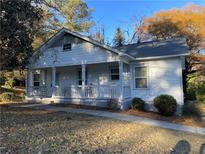 Charming white house with gray accents and a covered porch at 309 Hemphill School Nw Rd, Atlanta, GA 30331
