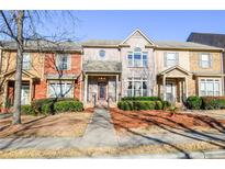 Brick front exterior of charming townhome with manicured landscaping at 6161 Thorncrest Dr, Tucker, GA 30084