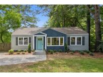 Newly renovated craftsman home with gray and blue siding, landscaped lawn, and charming front porch at 1010 Shepherds Ne Ln, Atlanta, GA 30324