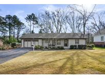 Ranch style home with attached garage and manicured lawn at 320 Chicopee Ne Dr, Marietta, GA 30060