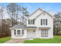 Two-story white house with gray shutters, landscaping, and a driveway at 9343 Haley Ct, Jonesboro, GA 30238