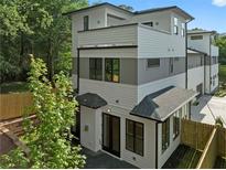 Modern three-story home with gray and white siding, and a black roof at 90 Cleveland Se St # B, Atlanta, GA 30316