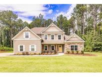 Two-story house with stone accents and a landscaped lawn at 45 Knight Ln, Mcdonough, GA 30252