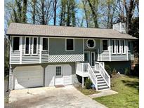 Gray two-story house with attached garage and deck at 3571 Quail Hollow Trl, Snellville, GA 30039