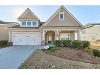 Attractive craftsman style home with a two car garage and manicured landscaping at 2678 Songbird Lane, Grayson, GA 30017