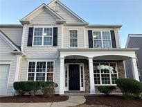 Two-story house with gray siding, stone accents, and a covered porch at 681 Courageous Ct, Lawrenceville, GA 30043