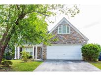 House exterior features stone accents and a two-car garage at 2545 Lake Royale Dr, Riverdale, GA 30296