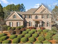 Brick two-story house with manicured landscaping and a large front yard at 2773 Carillon Xing, Marietta, GA 30066