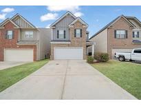 Two-story brick home with gray accents and a two-car garage at 3135 Hendrick Dr, Mcdonough, GA 30253