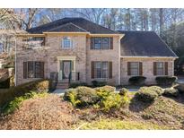 Brick two-story house with a gabled roof and landscaping at 4116 River Cliff Chase Se, Marietta, GA 30067