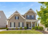 Two-story house with neutral siding, landscaping, and a covered porch at 207 Cross Rd, Acworth, GA 30102