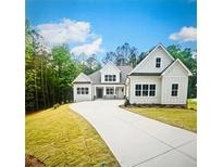 Two-story home with a large front yard and a three-car garage at 101 Forsyth Park Ln, Woodstock, GA 30188