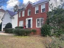 Two-story brick home with a large front yard and mature landscaping at 4382 Oakleaf Cv, Decatur, GA 30034