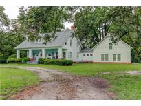 Charming white farmhouse with large wrap-around porch and detached building at 788 S Hwy 11 S, Social Circle, GA 30025