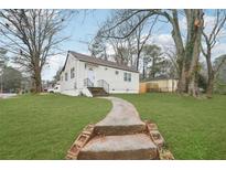 Cute bungalow with a landscaped lawn and walkway at 1288 Almont Sw Dr, Atlanta, GA 30310