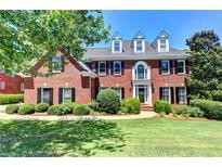 Brick house with landscaped lawn and walkway at 340 Kincardine Way, Alpharetta, GA 30022