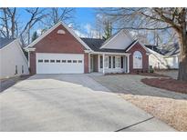 Brick and siding ranch home with attached garage and landscaped yard at 3297 Mcever Park Cir, Acworth, GA 30101