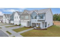 Exterior view of charming townhomes with attached garages and landscaping at 1112 Edinberg Dr # 57, Villa Rica, GA 30180