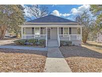 Gray house with white trim and porch, steps leading to the entrance at 1543 Broad Ne St, Conyers, GA 30012