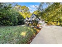 House exterior showing a two-story home with a long driveway and a large yard at 129 Talon Pl, Mcdonough, GA 30253