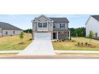 Two-story home with brick and siding, attached garage, and landscaping at 532 Vervain Drive, Locust Grove, GA 30248