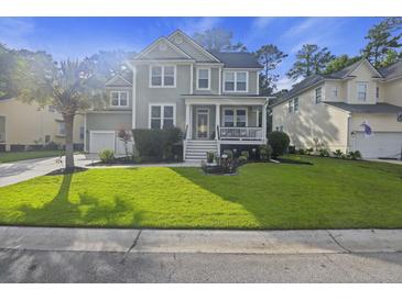 Two-story home with a charming front porch and landscaped yard at 3336 Toomer Kiln Cir, Mount Pleasant, SC 29466