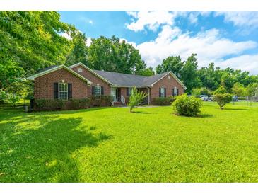 Brick ranch home with mature landscaping at 220 Carolina Ave, Moncks Corner, SC 29461