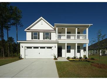 Two-story white farmhouse with a balcony and attached garage at 489 Eagleview Dr, Moncks Corner, SC 29461