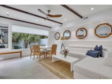 Bright living room with white sectional sofa and dining area at 40 Morris St, Charleston, SC 29403