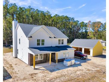New house and detached garage under construction, viewed from above at 517 Rendezvous Way, Huger, SC 29450