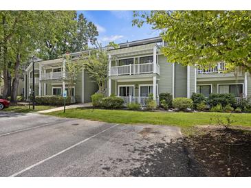 Green exterior of building with white trim, balconies, and parking at 2317 Tall Sail Dr # 1007 G, Charleston, SC 29414