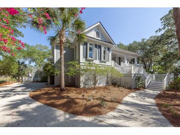 Charming two-story home with a wraparound porch and landscaped yard at 3064 Marshgate Dr, Seabrook Island, SC 29455