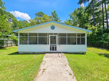 Charming one-story house with a screened porch and well-maintained lawn at 212 Hickory St, Walterboro, SC 29488