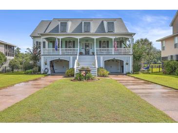 Two-story house with light blue exterior, white trim, and a double garage at 1374 Black River Dr, Mount Pleasant, SC 29466