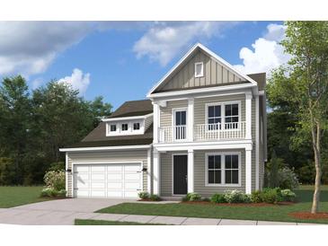 Two-story home with taupe siding, balcony, and attached garage at 5 Allamira Ln, Johns Island, SC 29455