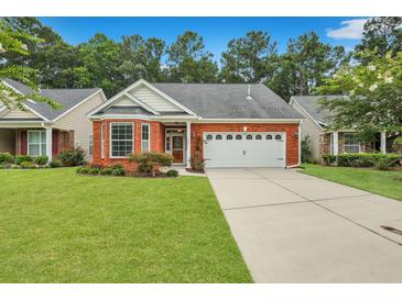 Brick ranch house with two-car garage and landscaped yard at 215 Angora Way, Summerville, SC 29485