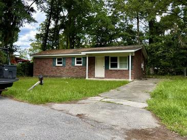 Brick ranch house with a driveway and front yard at 2628 Clara Ln, North Charleston, SC 29406