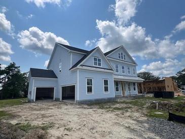 Two-story light blue house with a three-car garage at 1095 Saltwater Cir, Johns Island, SC 29455