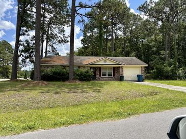 Ranch style home with mature trees and well-maintained yard at 4493 Outwood Dr, Ladson, SC 29456