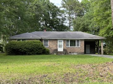 Brick ranch house with carport and mature landscaping at 6224 Bevington Rd, Hollywood, SC 29449